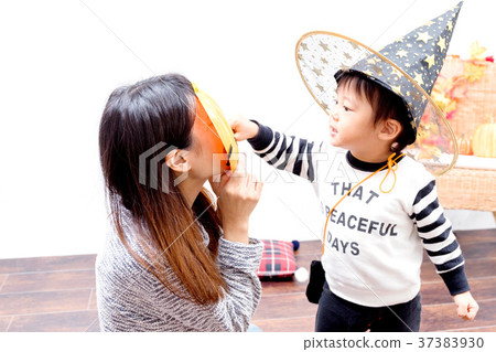 Toddlers and women playing with Halloween costumes 37383930