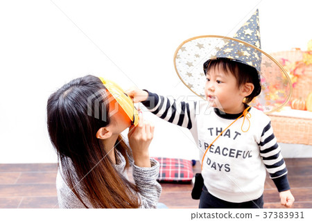 Toddlers and women playing with Halloween costumes Toddlers and women playing with Halloween costumes 37383931