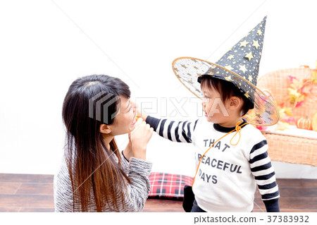 Toddlers and women playing with Halloween costumes Toddlers and women playing with Halloween costumes 37383932