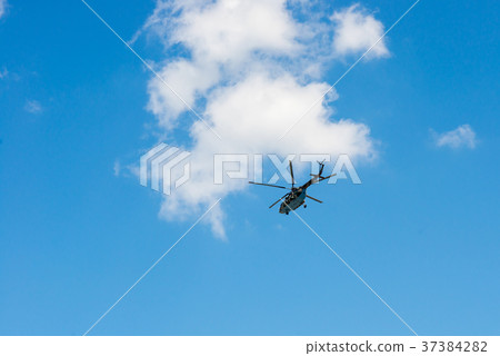Military helicopter against the blue sky 37384282