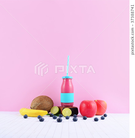 Pink smoothie with tropical fruits on white table. Pink smoothie with tropical fruits on white table. 37388741