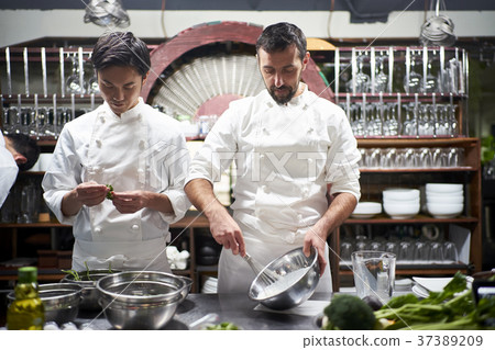 Chef cooking in the kitchen Chef cooking in the kitchen 37389209
