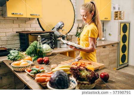 Young woman cooking on recipes, healthy eco food Young woman cooking on recipes, healthy eco food 37390791