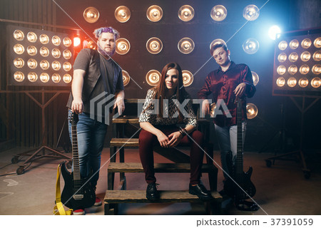 Musical group poses on the stage in night club 37391059