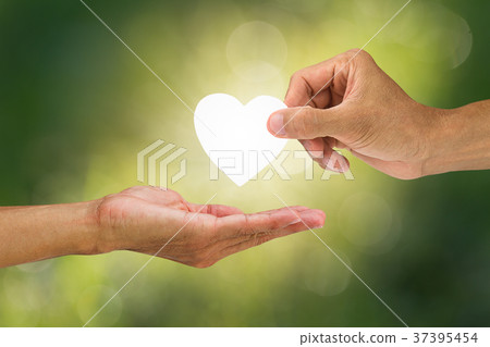 Hand holding and giving white heart 37395454