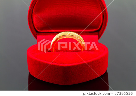 Gold ring in red heart shaped velvet  box 37395536
