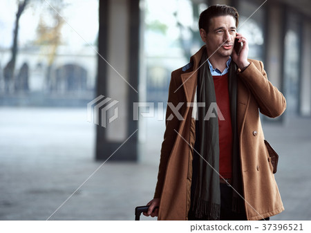 Cheerful male telling by phone 37396521