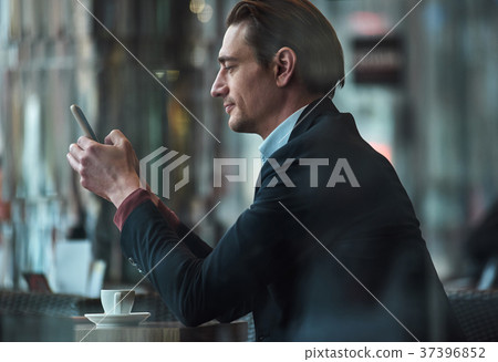 Serious male writing in phone Serious male writing in phone 37396852