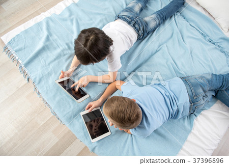 Two young boys using gadgets 37396896
