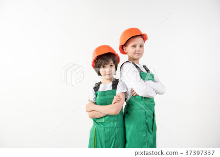 Adherent boys standing in constructor equipment 37397337