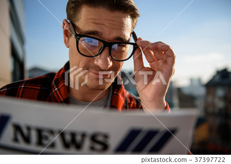 Serene adult male standing outside with the 37397722