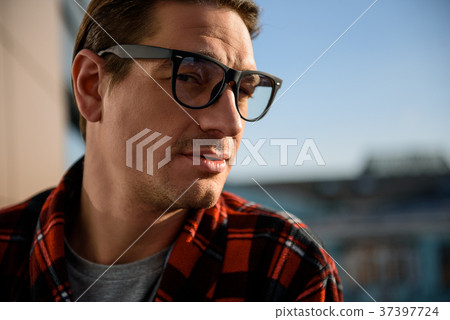 Serene man gazing and standing outside 37397724