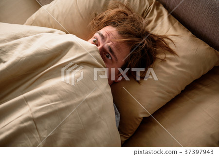 Panicked man unwilling to get up in the morning Panicked man unwilling to get up in the morning 37397943