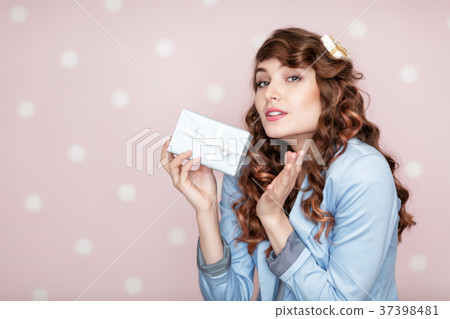 woman in blue jacket holds gift box. woman in blue jacket holds gift box. 37398481