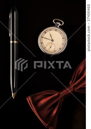 Pocket watch, pen and bow-tie are men's accessorie Pocket watch, pen and bow-tie are men's accessorie 37400468