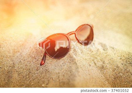 Sunglasses on the golden sand with reflections in Sunglasses on the golden sand with reflections in 37401032