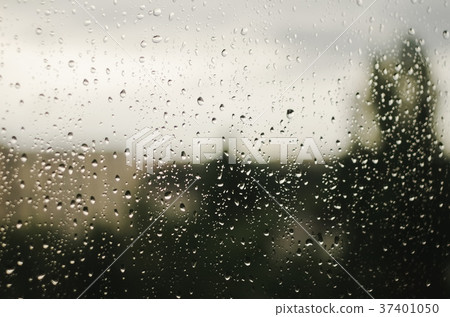 Raindrops on window with blurry trees as Raindrops on window with blurry trees as 37401050