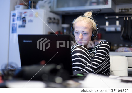 Adult woman in her casual home clothing working 37409871