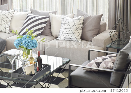 pillows in gray sofa and wine bottles on table pillows in gray sofa and wine bottles on table 37412023