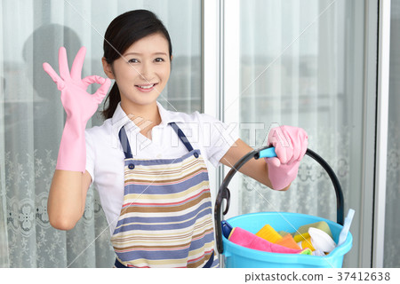 A woman with a cleaning tool A woman with a cleaning tool 37412638