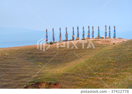 Wooden ritual pillars with colorful ribbons Hadak 37412778