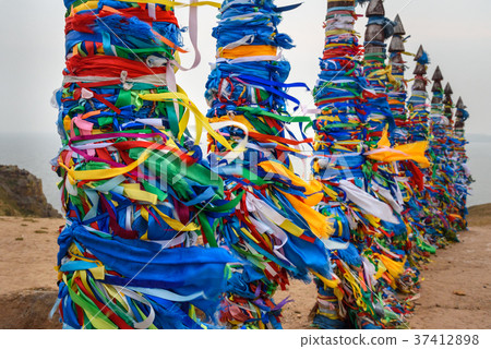 Wooden ritual pillars with colorful ribbons Hadak 37412898