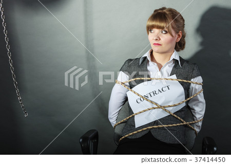 Upset businesswoman bound by contract terms. Upset businesswoman bound by contract terms. 37414450