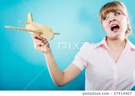Fly fear. Woman holding airplane in hand. Fly fear. Woman holding airplane in hand. 37414467