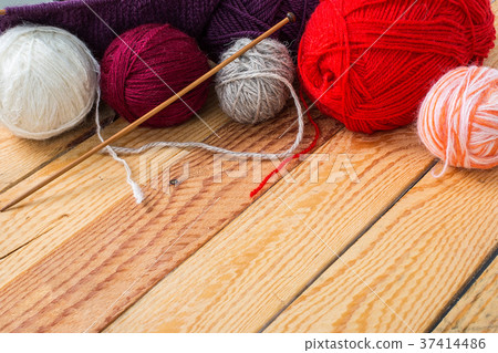 Colorful yarn balls on a wooden background Colorful yarn balls on a wooden background 37414486