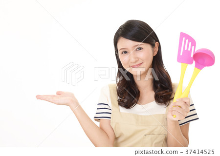 A woman enjoying cooking 37414525