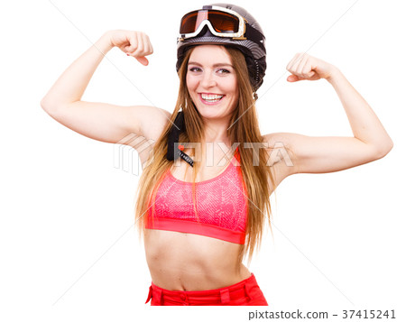 Woman wearing ski suit, helmet with goggles showing muscles 37415241