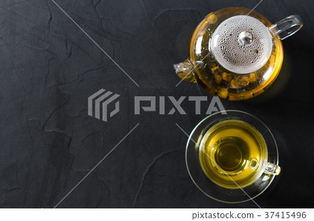Cup of delicious herbal tea and glass teapot. 37415496