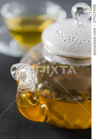 Cup of delicious herbal tea and glass teapot. 37415499