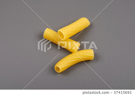 Rigatoni italian pasta isolated on grey background Rigatoni italian pasta isolated on grey background 37415691