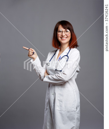 Photo of smiling brunette doctor in white coat and 37416241