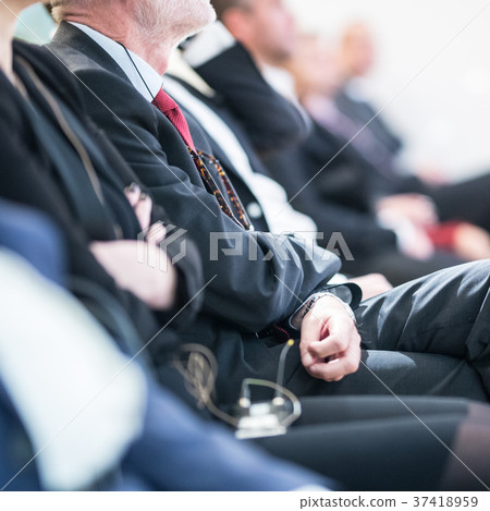 Row of business people sitting at seminar. Row of business people sitting at seminar. 37418959