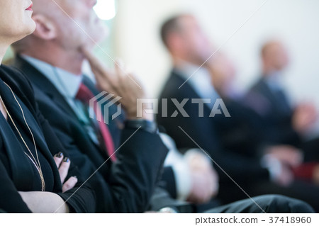 Row of business people sitting at seminar. Row of business people sitting at seminar. 37418960