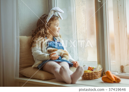 Cute happy little child girl is wearing bunny ears 37419646