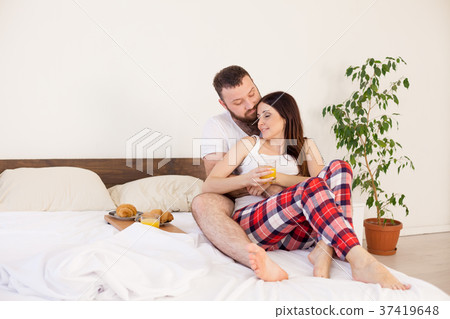 a man with a woman breakfast in bed in the morning 37419648