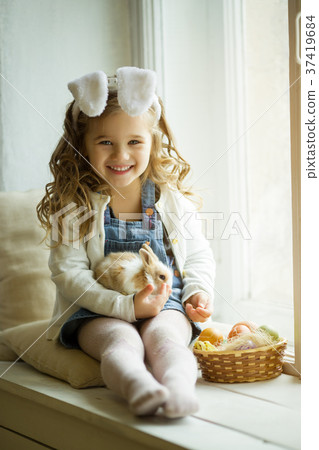 Cute little child girl is wearing bunny ears on 37419684