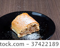 Slice of apple strudel on a black plate 37422189