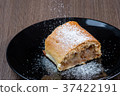 Slice of apple strudel on a black plate 37422191