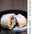 Two pieces of apple strudel on a black plate 37422193