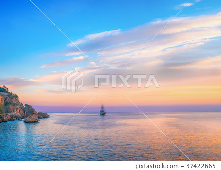 Tall ship sailing on sea in the evening sunlight Tall ship sailing on sea in the evening sunlight 37422665