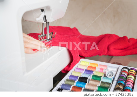 Woman sewing process in the phase of overstitchin Woman sewing process in the phase of overstitchin 37425392