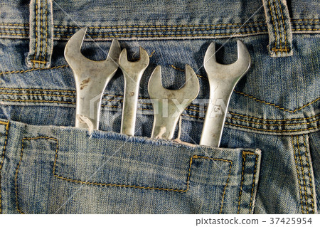 Wrench tools in the pocket of blue jeans 37425954