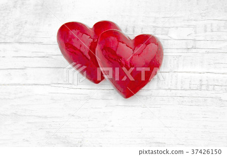 Two red hearts on white wooden background.  37426150