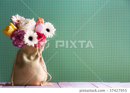 Colorful flowers in a jute bag Colorful flowers in a jute bag 37427955
