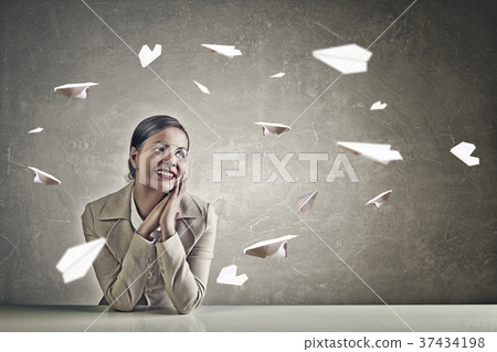 Attractive businesswoman sitting at table Attractive businesswoman sitting at table 37434198