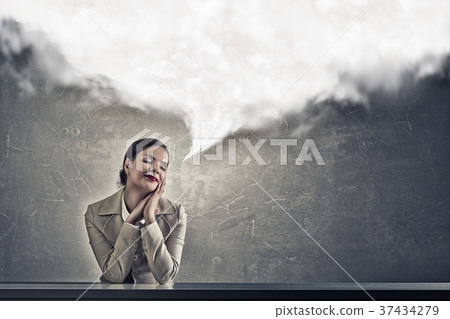 Attractive businesswoman sitting at table Attractive businesswoman sitting at table 37434279